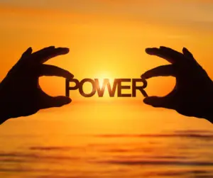 Silhouette of hands holding 'Power' at sunset, symbolizing the combined strength of IASIS MCN and Long Exhale Breathing to calm the nervous system.