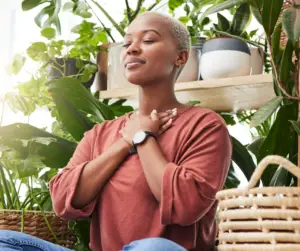 Woman sitting down smiling while doing breathwork